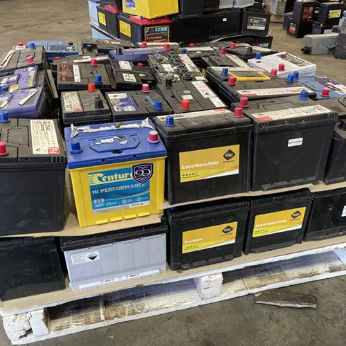 Stack of lead drained acid batteries scrap of different brands for sale at discount prices.