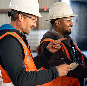 berg and collegue observing work and communicating